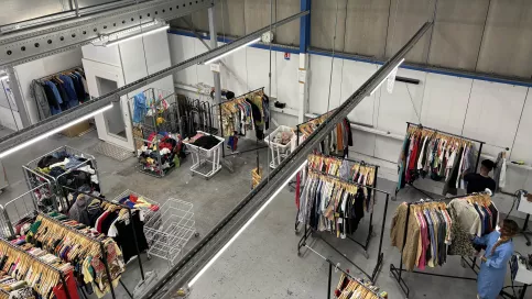 des portants de vêtements dans un hangar